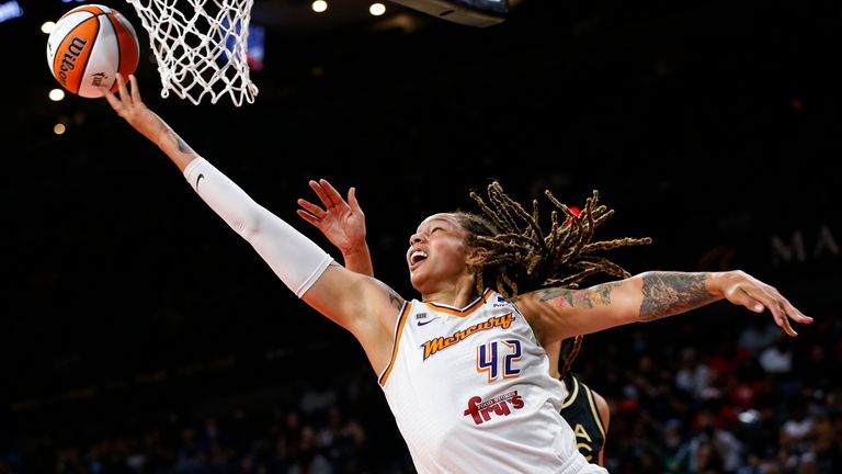 Phoenix Mercury center Brittney Griner (42) shoots around Las Vegas Aces center Liz Cambage during the first half of Game 5 of a WNBA basketball playoff series Friday, Oct. 8, 2021, in Las Vegas. (AP Photo/Chase Stevens)