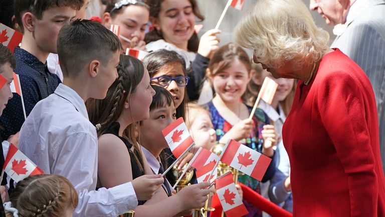 The Prince of Wales and Duchess of Cornwall are greeted by children as they arrive for their visit to Canada House in London, ahead of their forthcoming tour. Pic: PA