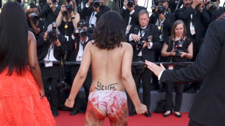 The Three Thousand Years of Longing premier in Cannes was interrupted by a woman protesting the reported sexual violence of Russian soldiers against women in Ukraine. Pic: AP
