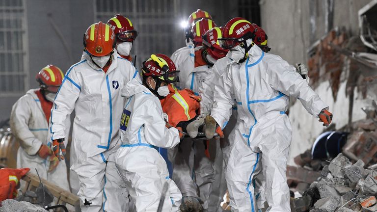 Rescue workers evacuate the 10th survivor pulled alive after being trapped 132 hours in the debris 