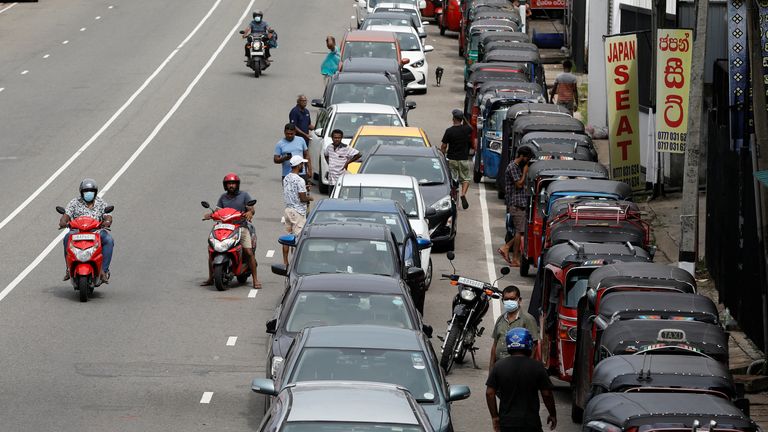 Drivers wait in a long queue to buy petrol at a fuel station in Colombo