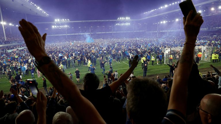 Everton fans invade the pitch after the match as they celebrate avoiding relegation from the Premier League 