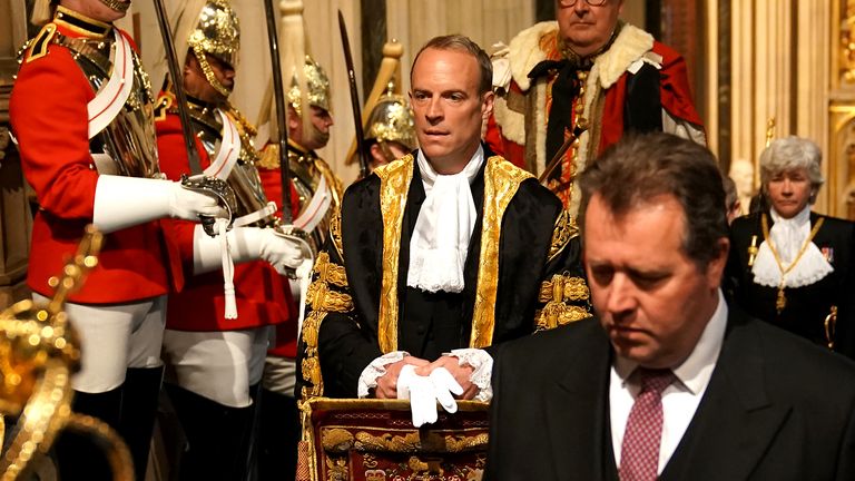 Justice Secretary Dominic Raab walks past the The Household Cavalry at the Palace of Westminster ahead of the State Opening of Parliament in the House of Lords, London. Picture date: Tuesday May 10, 2022.

