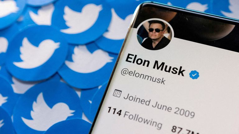 FILE PHOTO: Elon Musk's Twitter profile is seen on a smartphone placed on printed Twitter logos in this picture illustration taken April 28, 2022. REUTERS/Dado Ruvic/Illustration/File Photo
