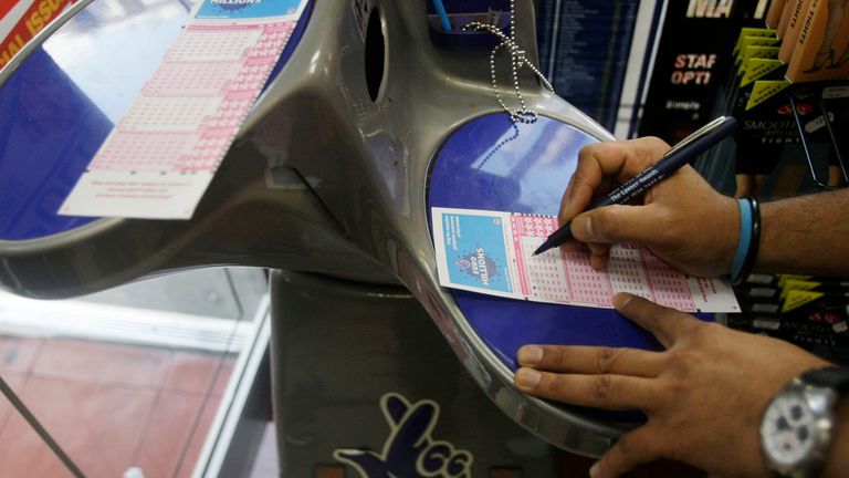 A man fills out a EuroMillions lottery form in a newsagents in London, Friday, Sept. 26, 2008. A jackpot of approximately 100 million pounds (US$190.8 million euro130 million) EuroMillions jackpot tonight will be the world&#39;s biggest lottery pay-out if it is won by a single player, Lottery organisers said. (AP Photo/Matt Dunham)