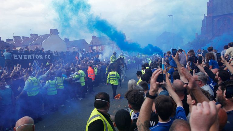 Fans let off flares outside the stadium before the match