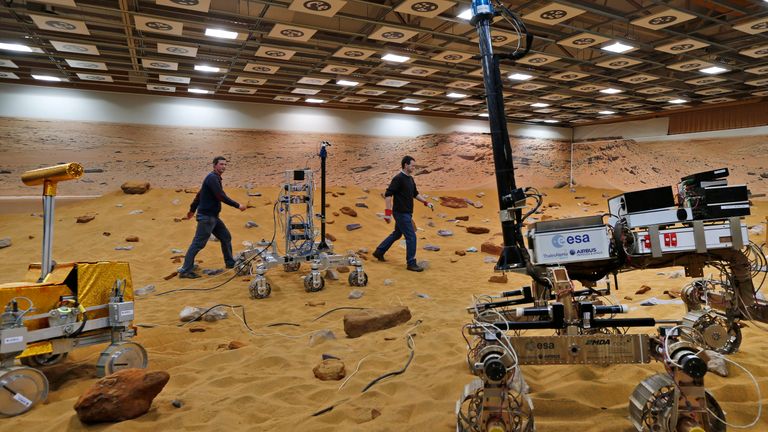 In this Thursday, March 27, 2014 file photo, personnel walk on the &#39;Mars Yard Test Area&#39;, a testing ground where robotic vehicles of the European Space Agency&#39;s ExoMars program scheduled for 2018, are tested in Stevenage, England. The U.K. Space Agency is looking for a catchy name for the ExoMars Rover being developed for use in a mission set for 2020. The agency launched a competition Friday, July 20, 2018 to find the best name for the rover, a key U.K. contribution to the European Space Agency