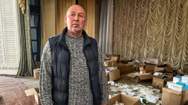 Georgiy Bystrov, who is a surgeon, shows us the banks of unpacked masks that have been donated