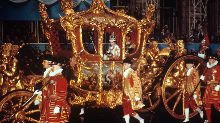Queen Elizabeth II riding in the gold state coach on her Coronation day

