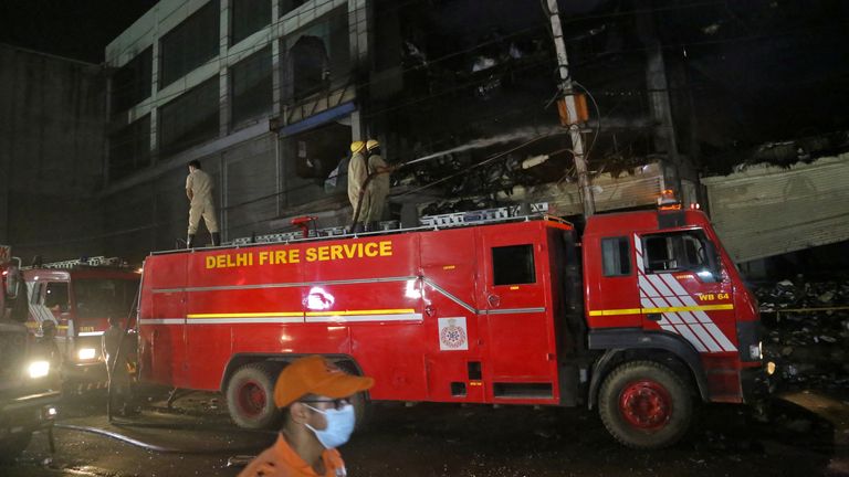 Firefighters douse a fire that broke out at a commercial building in Delhi&#39;s western suburb, India May 13, 2022. REUTERS/Stringer NO RESALES. NO ARCHIVES.
