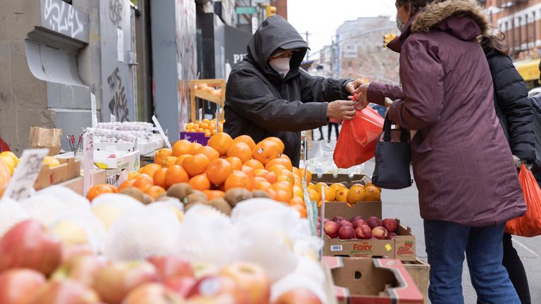 A person works at a stall selling fruit and vegetables in Manhattan, New York City, U.S., March 28, 2022