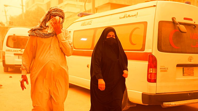 People cover their faces during a sandstorm in Baghdad. Iraq, on 16 May. Pic: AP