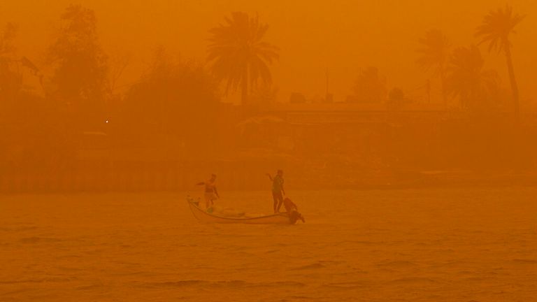 Fishermen continued working in Basra, Iraq, as a sandstorm hit the country on Monday. Pic: AP
