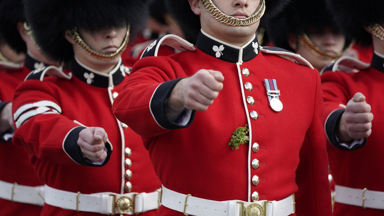 Sprigs of shamrock are seen on the tunic of members of the Irish Guards as they parade during a visit buy the Duke and Duchess of Cambridge to the 1st Battalion Irish Guards for the St Patrick&#39;s Day Parade, at Mons Barracks in Aldershot. Picture date: Thursday March 17, 2022.