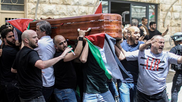 May 13, 2022, ---, Jerusalem: Palestinians shout at Israeli border police officers as they carry the coffin of Al Jazeera reporter Shireen Abu Akleh out of the hospital, before being taken away to her final resting place.  Abu Akleh, 51, a popular figure in the Arabic-language news service of Al-Jazeera channel, was shot dead on May 11 during a confrontation between Israeli soldiers and Palestinians in the city of Jenin, the Bank West.  Photo by: Ilia Yefimovich / picture-league / dpa / AP Images