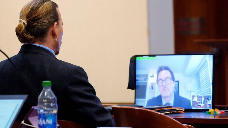 Jack Whigham, talent manager for Johnny Depp, is seen on a monitor as he testifies remotely in Fairfax County Circuit Court in a libel case against her by ex-husband Depp in Fairfax, Virginia, U.S. May 2, 2022. Steve Helber/Pool via REUTERS