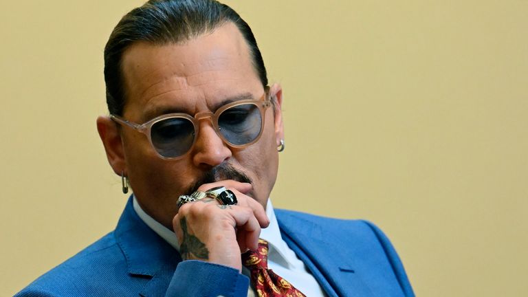US actor Johnny Depp listens during trial at the Fairfax County Circuit Courthouse in Fairfax, Virginia, on May 24, 2022. - Actor Johnny Depp is suing ex-wife Amber Heard for libel after she wrote an op-ed piece in The Washington Post in 2018 referring to herself as a ..public figure representing domestic abuse... (Photo by JIM WATSON / POOL / AFP)