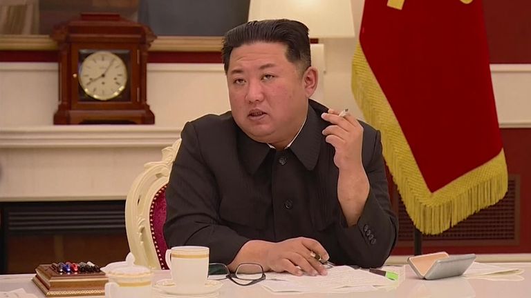 Kim Jong Un smokes during the meeting COVID