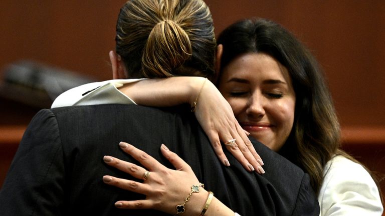 Lawyer Camille Vasquez embraces her client, actor Johnny Depp, in the courtroom