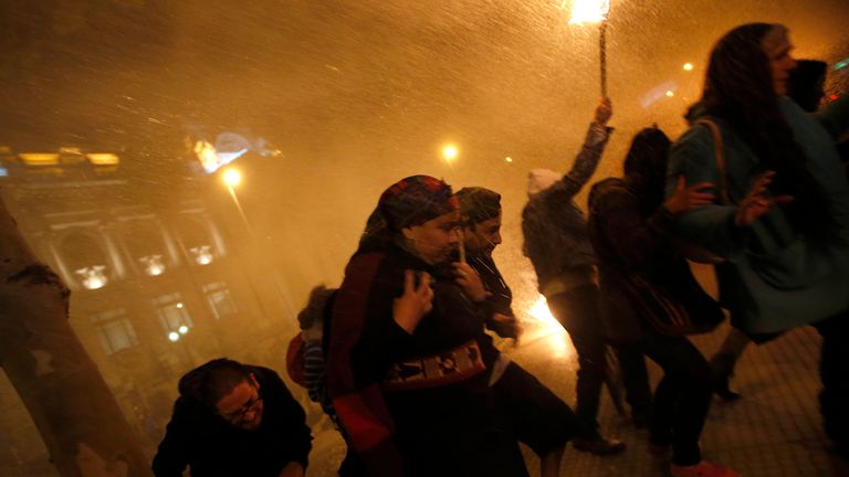 antiago
Mapuche Indians and supporters run away from a jet of water released from a police water cannon during a rally at Santiago, October 23, 2012. The rally was held in support of indigenous Mapuche inmates who have been on a hunger strike for 58 days to protest against charges of an attempted murder of a policeman and illegal possession of weapons, according local media. REUTERS/Ivan Alvarado (CHILE - Tags: POLITICS CRIME LAW CIVIL UNREST)