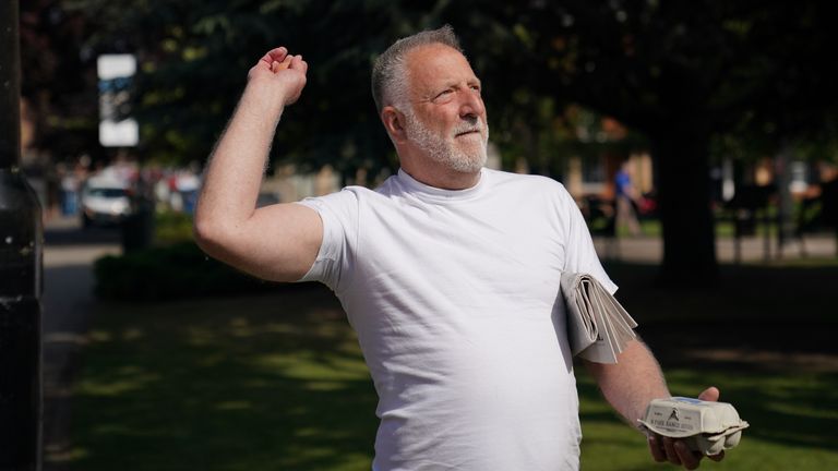 A man throws an egg at the monument, just hours after its erection