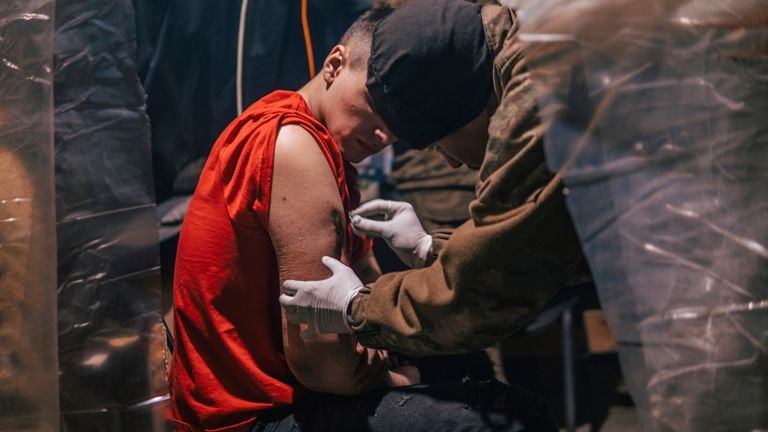 In this photo provided by Azov Special Forces Regiment of the Ukrainian National Guard Press Office, an Azov Special Forces Regiment&#39;s serviceman, injured during fighting against Russian forces, poses for a photographer inside the Azovstal steel plant in Mariupol, Ukraine, Tuesday, May 10, 2022. (Dmytro &#39;Orest&#39; Kozatskyi/Azov Special Forces Regiment of the Ukrainian National Guard Press Office via AP)