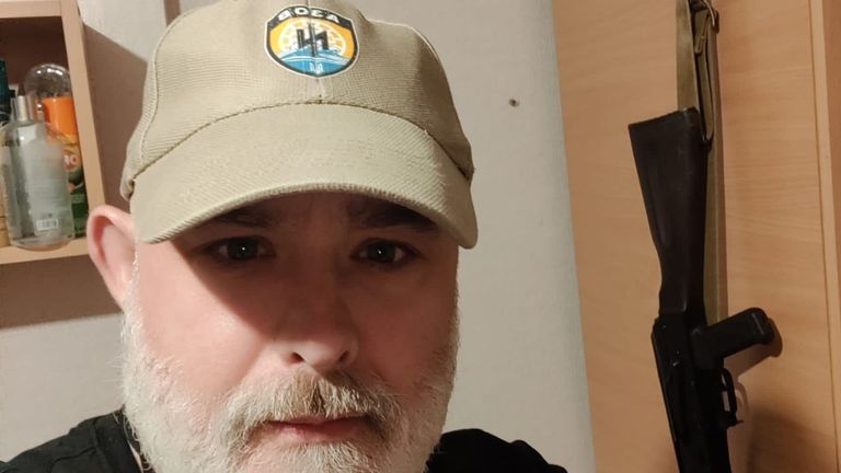 Mark Ayres wearing a hat with the Azov unit symbol