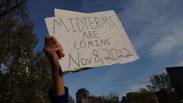 A demonstrator holds a sign reading "Midterms are Coming Nov 8, 2022" during a protest in support of abortion rights in front of the Massachusetts State House after the leak of a draft majority opinion written by Justice Samuel Alito, preparing for a majority of the court to overturn the landmark Roe v. Wade decision later this year, in Boston, Massachusetts, U.S., May 3, 2022. REUTERS/Brian Snyder