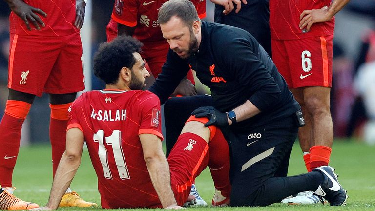 Liverpool&#39;s Mohamed Salah receives medical attention after sustaining an injury