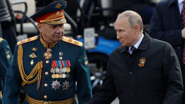 Russian President Vladimir Putin and Defence Minister Sergei Shoigu speak after a military parade on Victory Day, which marks the 77th anniversary of the victory over Nazi Germany in World War Two, in Red Square in central Moscow, Russia May 9, 2022. REUTERS/Maxim Shemetov
