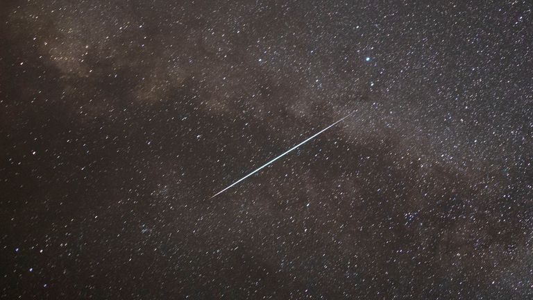 A meteor streaks past stars in the night sky during the annual Perseid meteor shower at the Negev Desert in southern Israel, August 13, 2021. REUTERS/Amir Cohen
