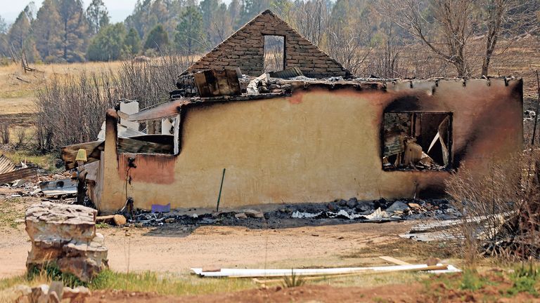 A burnt home following a wildfire is seen in Sapello, New Mexico, on Tuesday, May 10, 2022. The largest wildfire burning in the United States was heading toward mountain resort towns in northern New Mexico on Wednesday, prompting officials to issue another set of warnings for more people to prepare to evacuate as the fast-moving fire picks up momentum. (Luis Sanchez Saturno/The New Mexican via AP) 