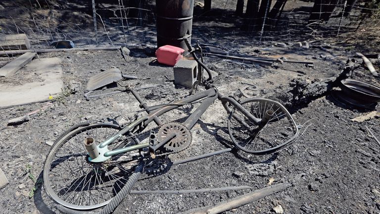 A burnt bicycle is among the remains of a burnt mobile home in the community of San Ignacio following a wildfire near Las Vegas, New Mexico, on Tuesday, May 10, 2022. The largest wildfire burning in the United States was heading toward mountain resort towns in northern New Mexico on Wednesday, prompting officials to issue another set of warnings for more people to prepare to evacuate as the fast-moving fire picks up momentum. (Luis Sanchez Saturno/The New Mexican via AP) 