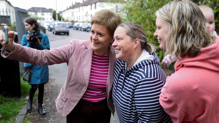 Scotland&#39;s First Minister and Scottish National Party (SNP) leader Nicola Sturgeon takes a selfie outside a polling station during the local elections in Glasgow, Scotland May 5, 2022. REUTERS/Russell Cheyne

