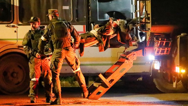 A wounded service member of Ukrainian forces from the besieged Azovstal steel mill in Mariupol is transported on a stretcher out of a bus, which arrived under escort of the pro-Russian military in the course of Ukraine-Russia conflict in Novoazovsk, Ukraine May 16, 2022. REUTERS/Alexander Ermochenko TPX IMAGES OF THE DAY