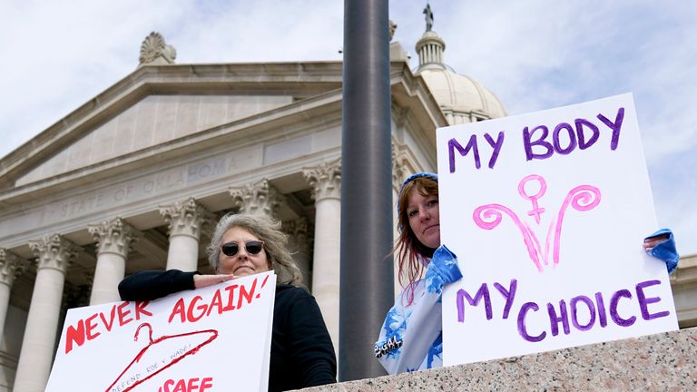 FILE - Dani Thayer, left, and Marina Lanae, right, both of Tulsa, Okla., hold pro-choice signs at the State Capitol, Wednesday, April 13, 2022, in Oklahoma City.  Oklahoma's Republican-led state legislature has passed several anti-abortion restrictions in recent weeks, part of a move in conservative states to curb women's reproductive rights.  Anti-abortion lawmakers are hoping the conservative-leaning U.S. Supreme Court might even overturn national law that's been around for nearly 50 years.  (AP Photo/File Sue Ogrocki)