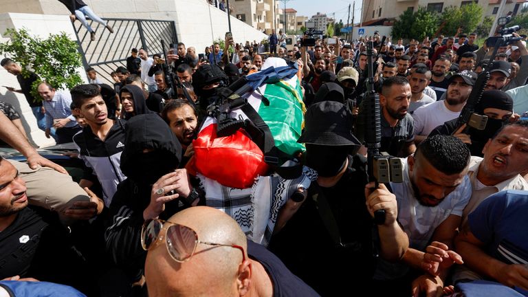 Palestinian carry the body of Al Jazeera reporter Shireen Abu Akleh, who was killed by Israeli army gunfire during an Israeli raid, the Qatar-based news channel said, in Jenin in the Israeli-occupied West Bank May 11, 2022