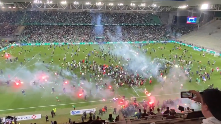 Fans invaded the pitch and set off flares after Saint-Etienne lost 5-4 on penalties to Auxerre.