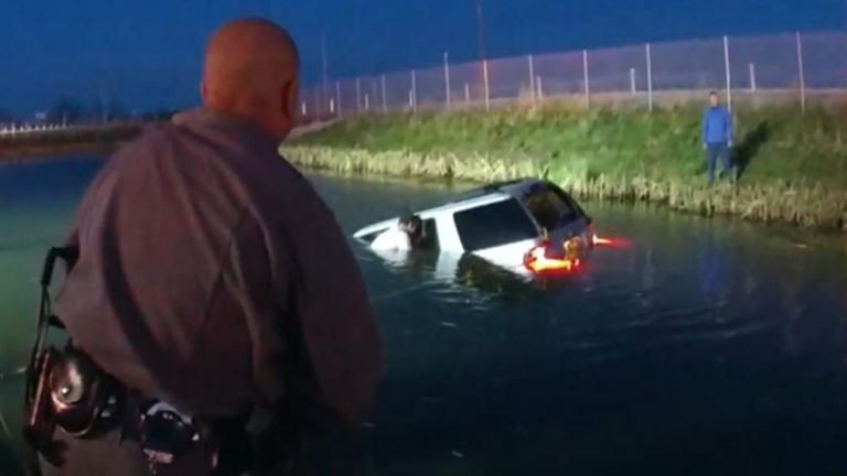 Dramatic moment police rescue driver from sinking car