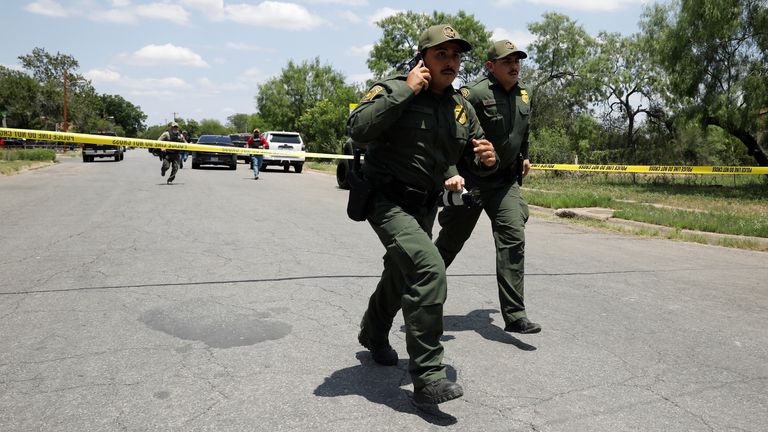 Law enforcement personnel run away from the scene of a  shooting near Robb Elementary School in Uvalde, Texas, U.S. May 24, 2022.  REUTERS/Marco Bello