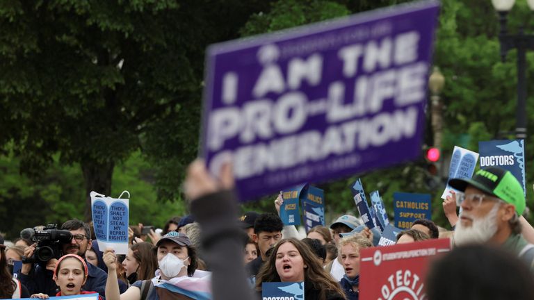 Demonstrators hold signs during a protest outside the U.S. Supreme Court after the leak of a draft majority opinion written by Justice Samuel Alito preparing for a majority of the court to overturn the landmark Roe v. Wade abortion rights decision later this year, in Washington, U.S. May 3, 2022. REUTERS/Evelyn Hockstein
