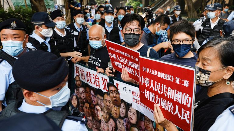 Pro-democracy protesters hold a banner during a protest urging for the release of political prisoners at Chinese National Day, in Hong Kong, China October 1, 2021. REUTERS/Tyrone Siu