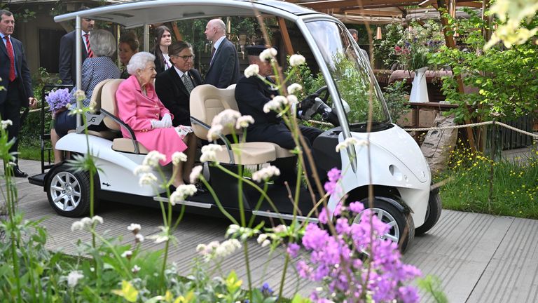 Queen Elizabeth is given a tour in a buggy as she visits the Chelsea Flower Show in London
