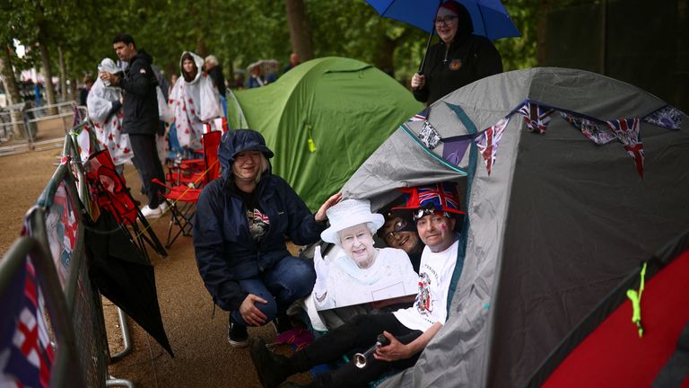 Royal fan John Loughrey poses with a cutout of Queen Elizabeth, in his tent he has put up to camp outside Buckingham Palace for the Queen’s Platinum Jubilee celebrations, in London, Britain, May 31, 2022. REUTERS/Henry Nicholls