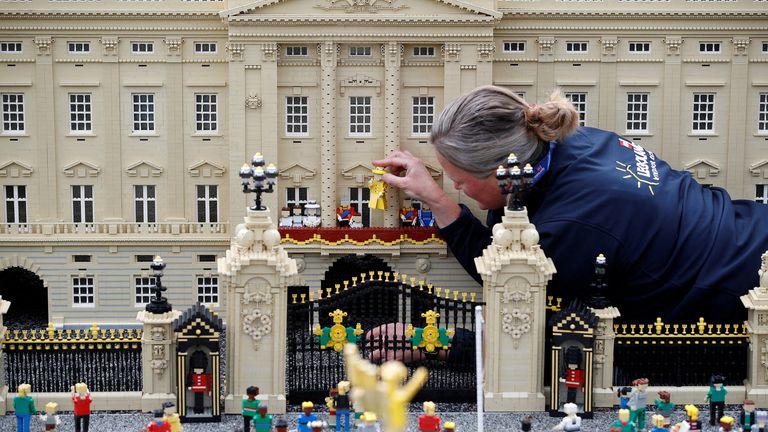 Legoland modeller Paula Young poses for a photograph while completing a model of a scene at Buckingham Palace, at Legoland in Windsor, Britain, May 31, 2022. REUTERS/Peter Nicholls