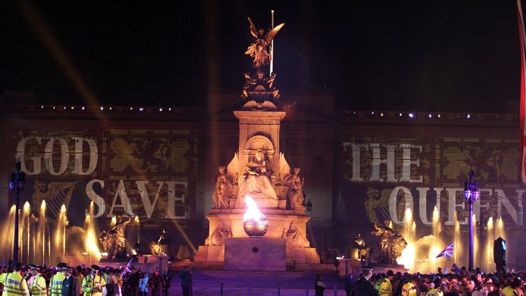 Queen Elizabeth II lit the final beacon, outside Buckingham Palace,  to commemorate her Golden Jubilee. Earlier, some 12,000 people had watched the Party in the Palace - the second concert to be held in the grounds in three days.  * ... ten of thousands more gathered outside to enjoy the music.  On Tuesday she will travel to the St Paul&#39;s for a service of thanksgiving.