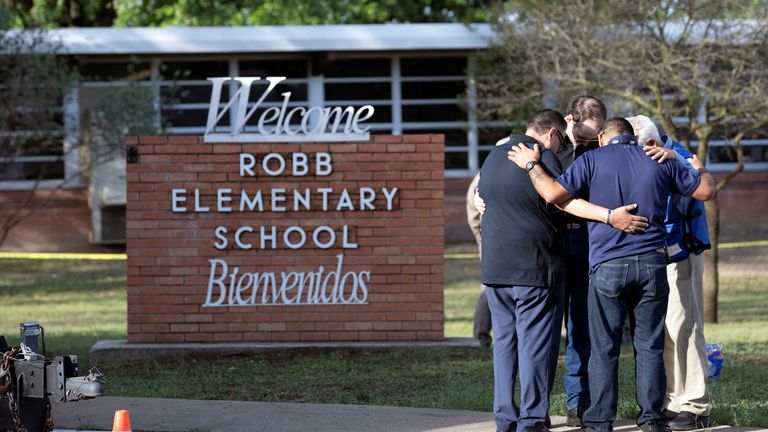 People gather at Robb Elementary School, the site of a mass shooting in Uvalde, Texas, U.S., May 25, 2022.  REUTERS/Nuri Vallbona