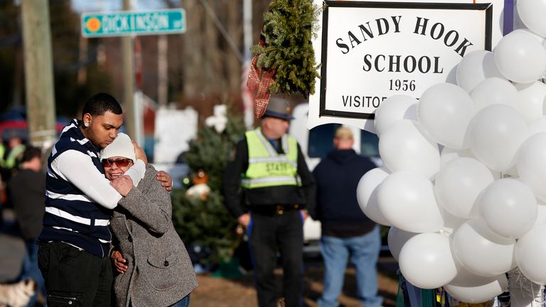 Mourners gather outside Sandy Hook Elementary School in December 2012