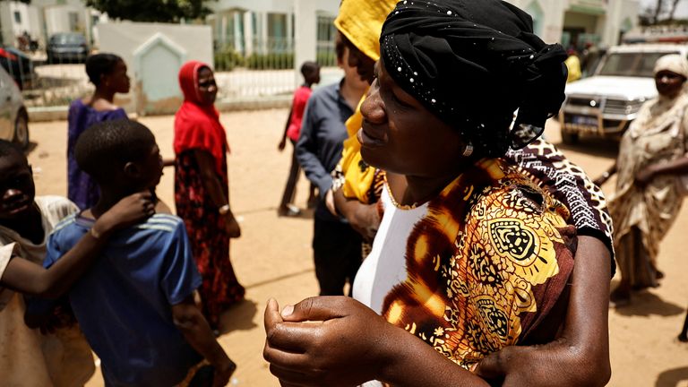 A pregnant woman, who according to her mother has reached her term, is seen walking outside hospital after she was refused admission at the hospital