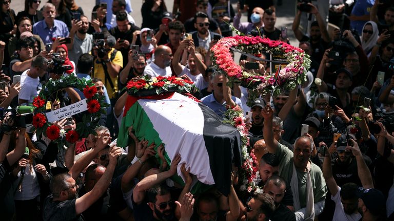 Family and friends of Al Jazeera reporter Shireen Abu Akleh, who was killed during an Israeli raid in Jenin in the occupied West Bank, carry her body as she arrives in Jerusalem, May 12, 2022. REUTERS/Ammar Awad
